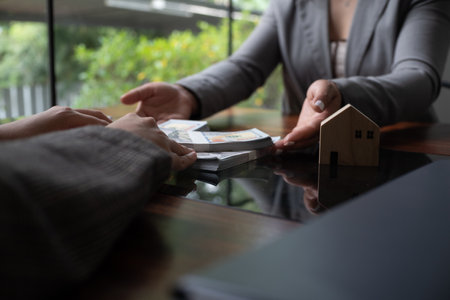 Real estate agent presenting and approved home loan contract. Real estate investment, Home mortgage concept.の写真素材