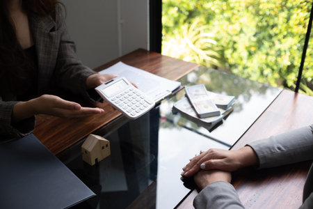 Real estate agent presenting and approved home loan contract. Real estate investment, Home mortgage...