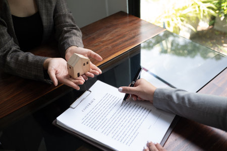 Real estate agent presenting and approved home loan contract. Real estate investment, Home mortgage concept.の写真素材