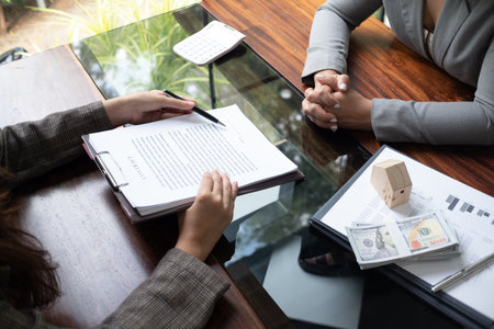 Real estate agent presenting and approved home loan contract. Real estate investment, Home mortgage concept.の写真素材