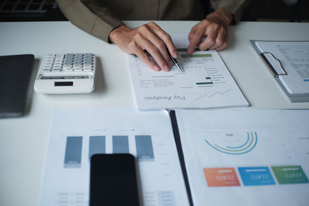 Businessman reading report in office desk analyse data for plan project