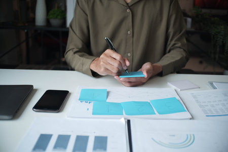 Businessman reading report in office desk analyse data for plan projectの写真素材