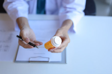 Doctor or General practitioner explain to patient how to use prescribed medicine correctly by explain dosage, frequency, and timing.の写真素材