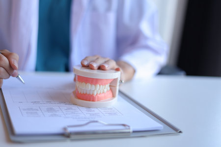 Dentist working in office writing diagnose oral health issues.の写真素材