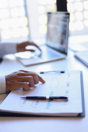 Businessman working in office reading documents analyze data for project planning.の写真素材
