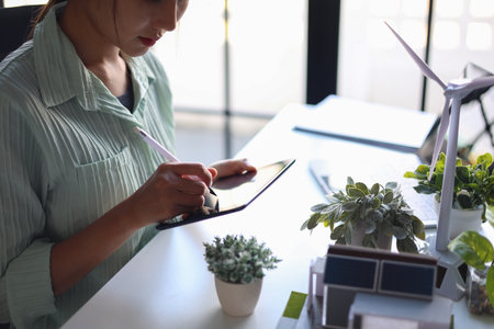 Beautiful engineer working in office design eco friendly and sustainable living home.の写真素材