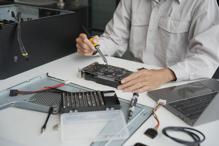Computer Hardware technicians fixing computer PC.