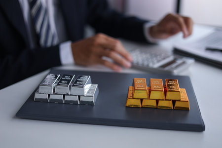 Businessman investing in precious metals gold and silver to diversify portfolios hedge against inflation and currency depreciation.の写真素材