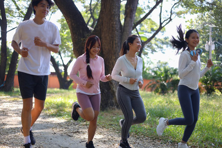 Group of Young Adults Jogging in Park