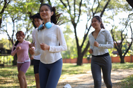 Group of Young Adults Jogging in Park