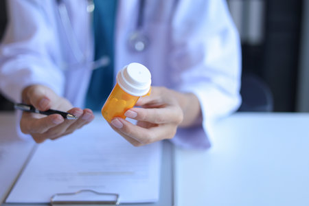 Doctor or General practitioner explain to patient how to use prescribed medicine correctly by explain dosage, frequency, and timing.の写真素材