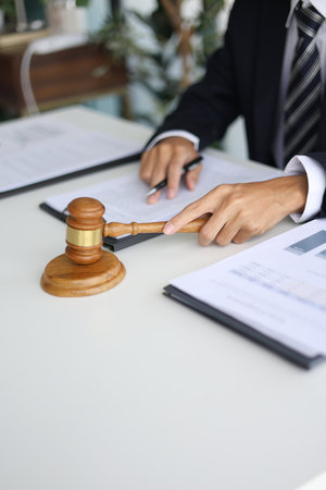 Legal counsel reading contract paperwork to finalize a legal agreement. Concepts for legal counsel, judicial authority, and the finality of a decision or agreement.Â の写真素材