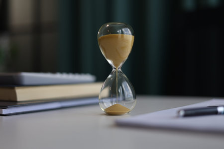 Sand clock on office desk. Concept for counting down and time management.