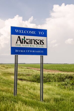 State of Arkansas welcome sign tells you it is The Natural State and to buckle up for safetyの写真素材