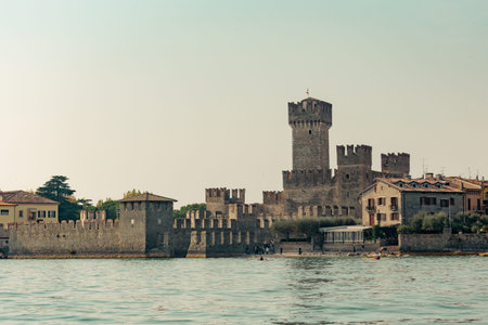 Medieval castle Scaliger on Lake Garda in autumn sunrise, Sirmione, Italy