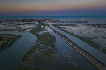 Aerial view of the road to Grado at low tide at dawn.の写真素材