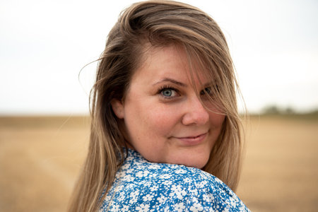 Happy and satisfied beautiful plus size model outdoor.の写真素材