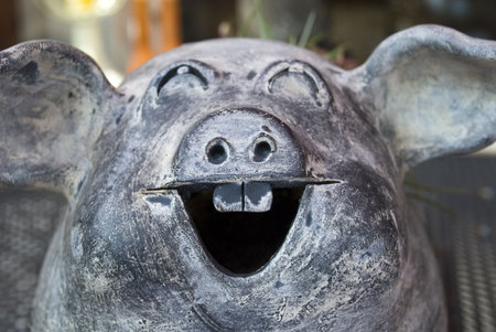 A ceramic pig pottery in the colors of nature, grey and brownの写真素材