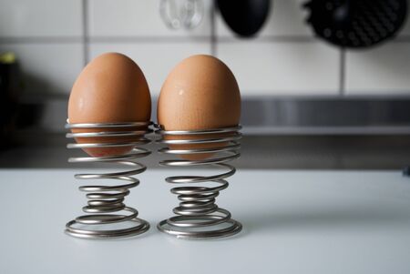 Two eggs in a spiral cup in kitchenの写真素材