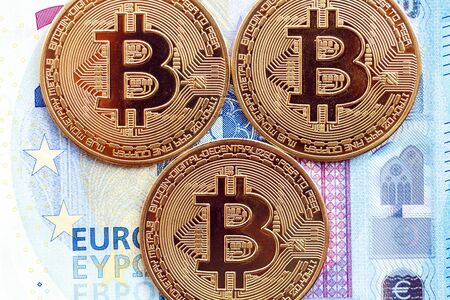 Bitcoin coins on the background of 20 euro bills. close-upの写真素材