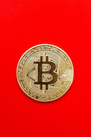 Bitcoin gold coin on a red background.の写真素材