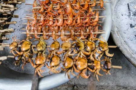 typical Vietnamese food healthy dishes with baked crawfish, small fish, crabsの写真素材