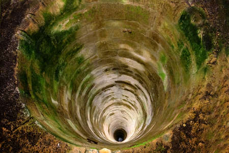 deep stone well in the castle Red stone Cerveny kamenの写真素材