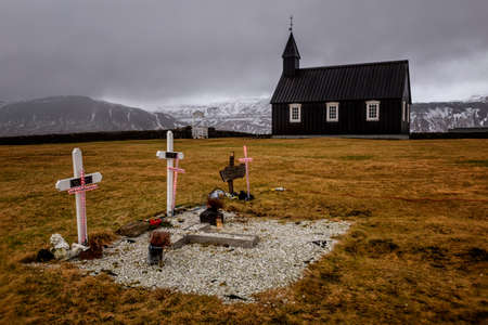 black church Budakirkja with graves with a crossの写真素材