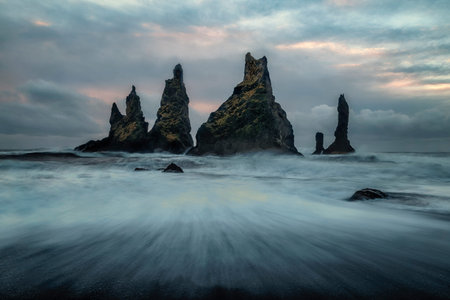 rocky outcrops protruding from the sea off the coast