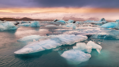 sunset in a glacial lagoon under the iceberg