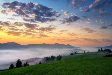 beautiful landscape with valleys, lakes and rivers in Pieniny mountains in fogの写真素材
