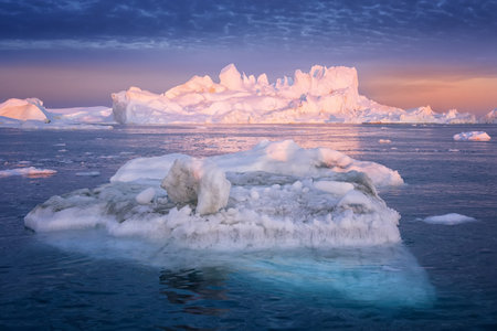 floating glaciers in the rays of the setting sun at polar night