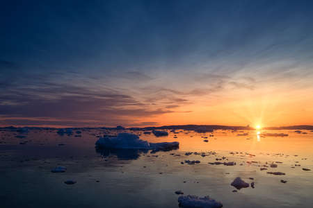 floating glaciers in the rays of the setting sun at polar nightの写真素材
