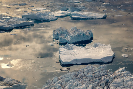 floating glaciers in the rays of the setting sun at polar night