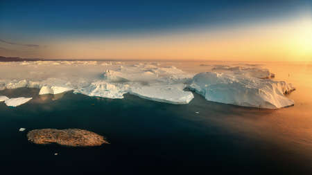floating glaciers in the rays of the setting sun during a polar nightの写真素材