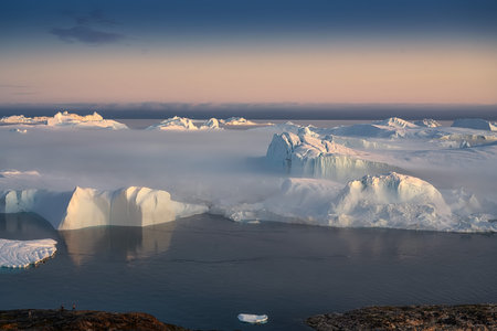 floating glaciers in the rays of the setting sun during a polar night