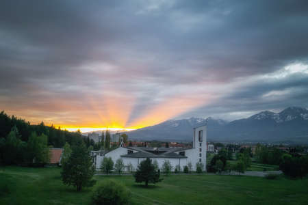 sunset at the church in Svit with the rays of the sunの写真素材