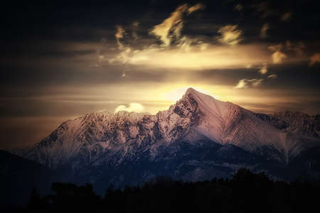 moonrise behind the Tatra mountain Krivan with cloudsの写真素材