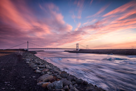 Jokulsarlon glacial river lagoon in southern part of Vatnajokull National Park with suspension bridgeの写真素材