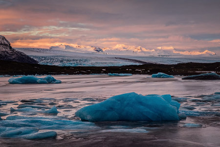 ice floes on the black sand and the coast Fjallsarlon lagoon