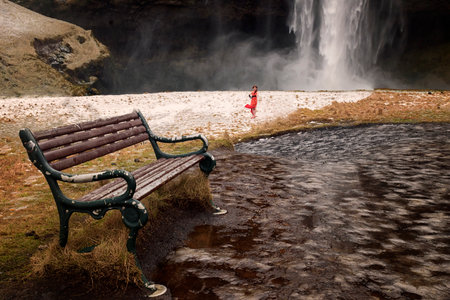 An impressive cascade, majestic waterfall seen from a cave behindの写真素材