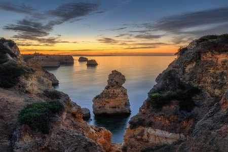 Praia da Mesquita sunrise with rocks and colour skyの写真素材