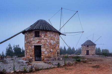 old windmills Moinhos da Serra da Atalhada at morning fogの写真素材