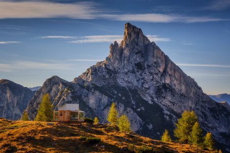 Sass de Stria mountain in the light of the setting sun near Passo Falzarego with cabin lodgeの写真素材