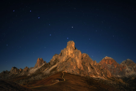 view from Passo Giau to Mount Gusela and Nuvolau at night with stars and Milky wayの写真素材