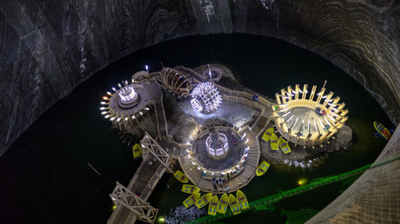 view of the lake in the historic Salina Turda salt mine with yellow boats in Romaniaの写真素材