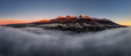 fog under the High Tatras at sunrise near the village of Gerlachov in Slovakiaの写真素材