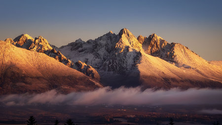 Lomnicky peak at sunset with fog from Popradの写真素材