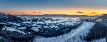 view of the Liptov basin in winter, with Liptovska Mara and Chopok in the backgroundの写真素材