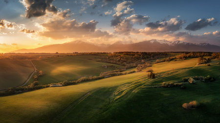 view of the Western Tatras and meadows at sunsetの写真素材